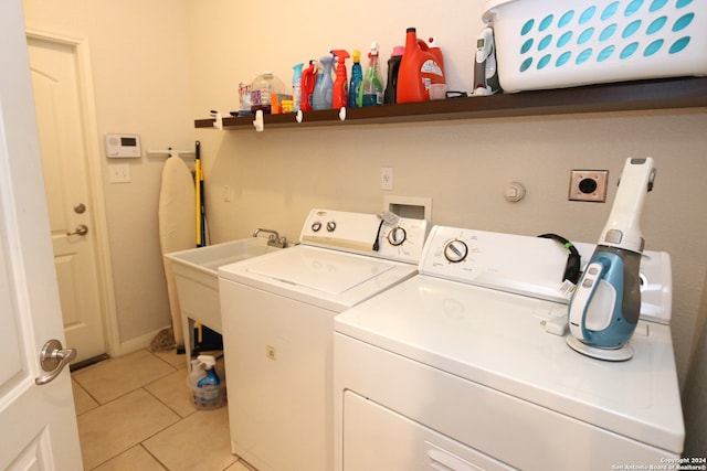 washroom with independent washer and dryer and light tile patterned floors