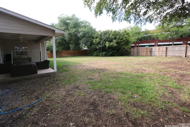 view of yard with ceiling fan