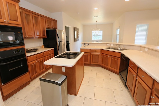 kitchen with brown cabinets, black appliances, a sink, light countertops, and light tile patterned floors
