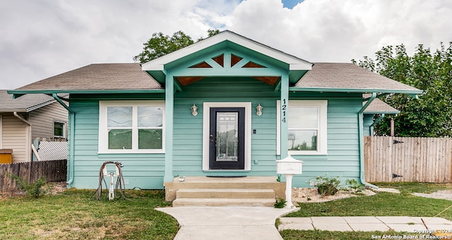 bungalow-style house with a front lawn