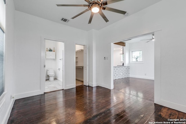 empty room with ceiling fan and dark wood-type flooring