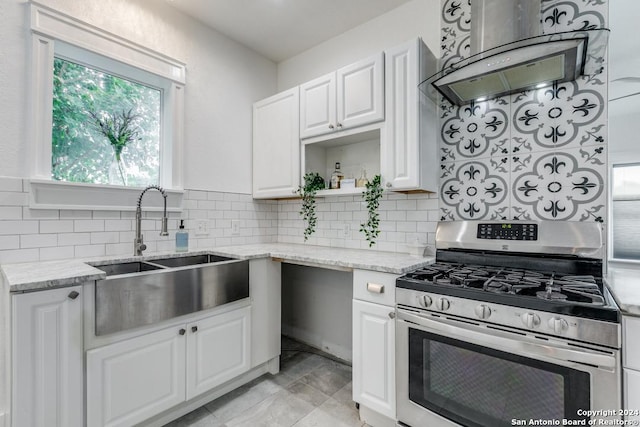 kitchen with range hood, sink, stainless steel gas range, white cabinets, and light stone counters