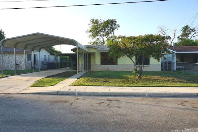 view of front of home with a carport and a front lawn