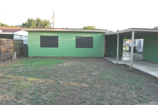 rear view of property featuring a carport