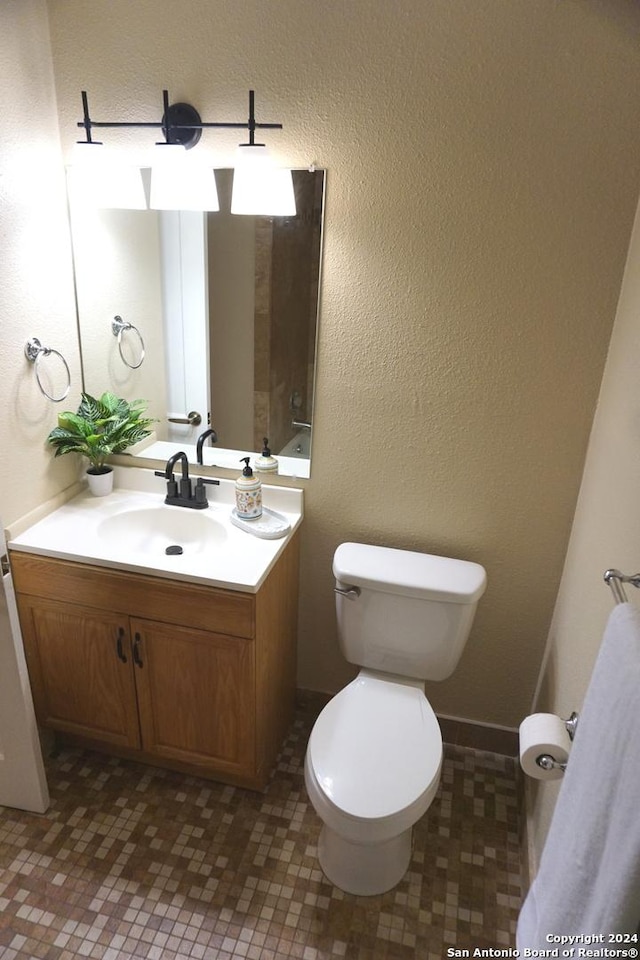 bathroom with vanity, toilet, and tile patterned flooring