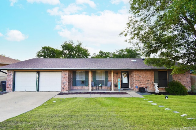 ranch-style house featuring a garage, a front yard, and a porch