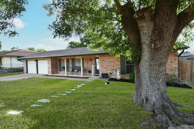 single story home with a garage and a front lawn