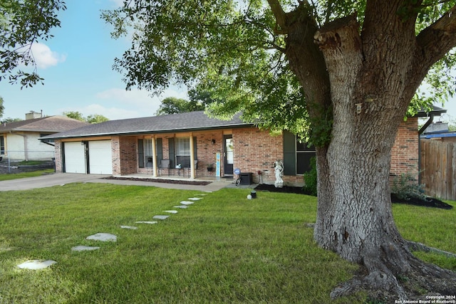 ranch-style home with a porch, a garage, and a front yard