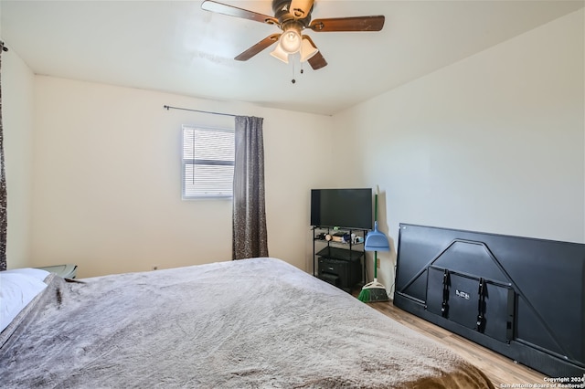 bedroom with hardwood / wood-style floors and ceiling fan