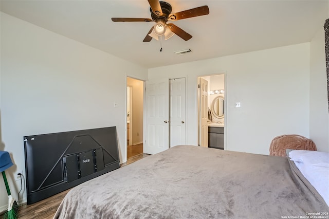 bedroom with connected bathroom, ceiling fan, and hardwood / wood-style floors