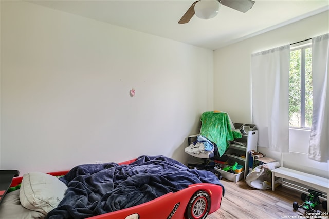 bedroom featuring hardwood / wood-style floors and ceiling fan