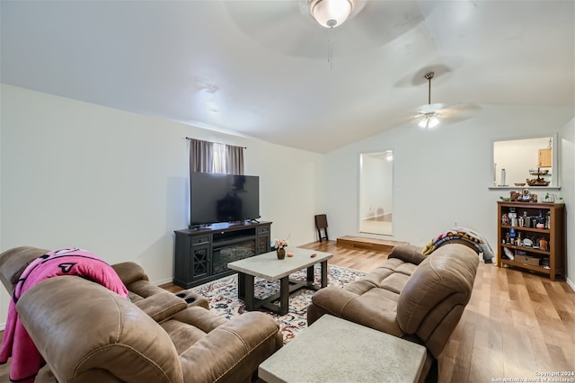 living room featuring vaulted ceiling, ceiling fan, and light wood-type flooring