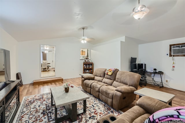 living room with a wall unit AC, light wood-type flooring, ceiling fan, and lofted ceiling