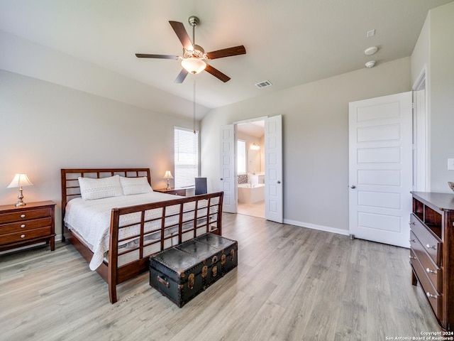 bedroom featuring ceiling fan, ensuite bathroom, visible vents, baseboards, and light wood finished floors