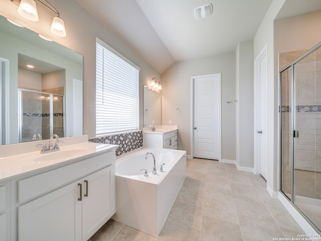 bathroom featuring independent shower and bath, tile patterned floors, a wealth of natural light, and dual bowl vanity