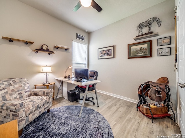 office space with light wood-style floors, baseboards, and a ceiling fan