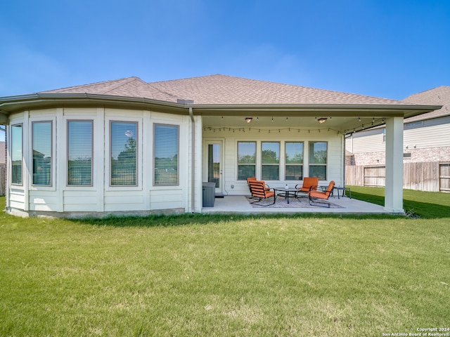 rear view of house with a yard and a patio area