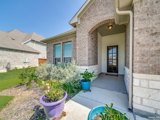 property entrance featuring brick siding