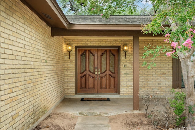 view of exterior entry with a porch