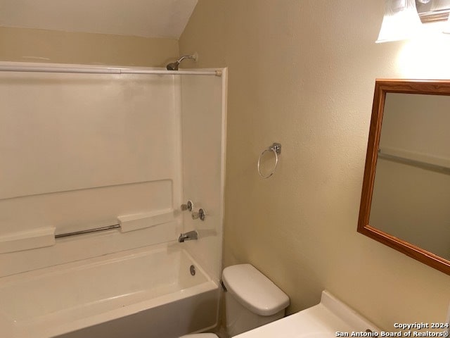 bathroom featuring vaulted ceiling, shower / bath combination, and toilet