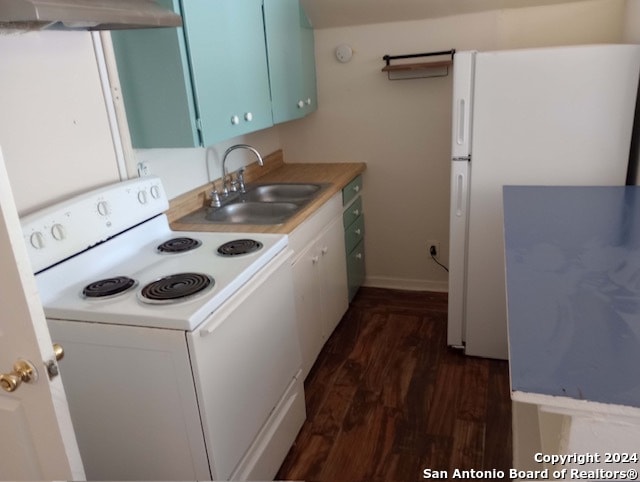 kitchen with sink, dark hardwood / wood-style flooring, white appliances, and wall chimney exhaust hood