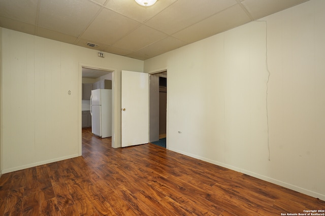 unfurnished room featuring hardwood / wood-style floors and a drop ceiling