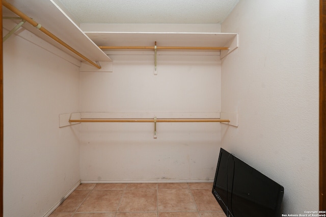 spacious closet with light tile patterned flooring