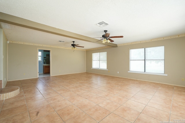 tiled empty room featuring a textured ceiling and ceiling fan