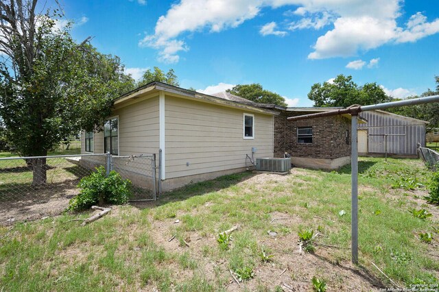 rear view of property with central AC