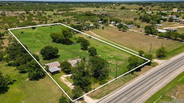 birds eye view of property with a rural view