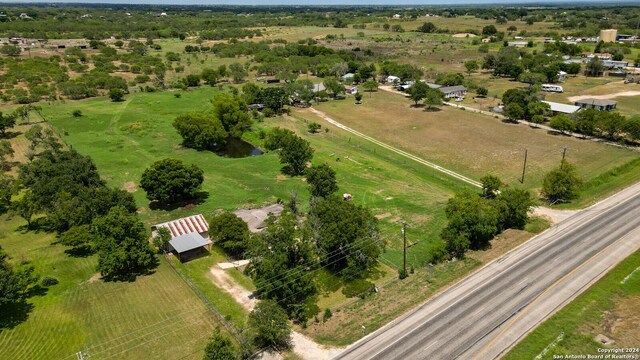 birds eye view of property with a rural view