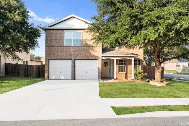 view of property with a garage and a front lawn