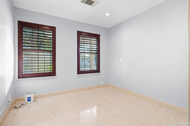 spare room featuring plenty of natural light and tile patterned floors