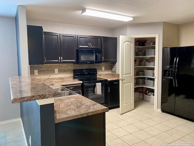 kitchen with black appliances, sink, kitchen peninsula, backsplash, and light tile patterned flooring