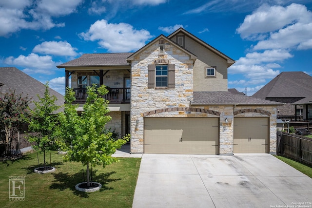 french country home featuring a balcony, stone siding, driveway, and a front yard