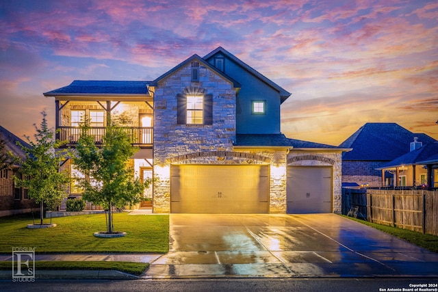 view of front of home with stone siding, a lawn, and concrete driveway