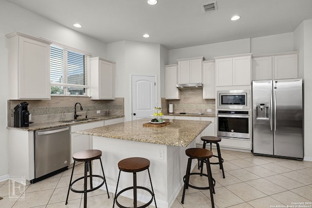 kitchen featuring white cabinets, a center island, sink, and stainless steel appliances