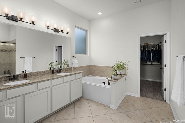 bathroom with plus walk in shower, vanity, and tile patterned floors