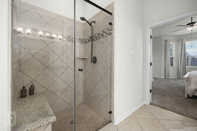 bathroom with ceiling fan, tile patterned flooring, and a shower with door