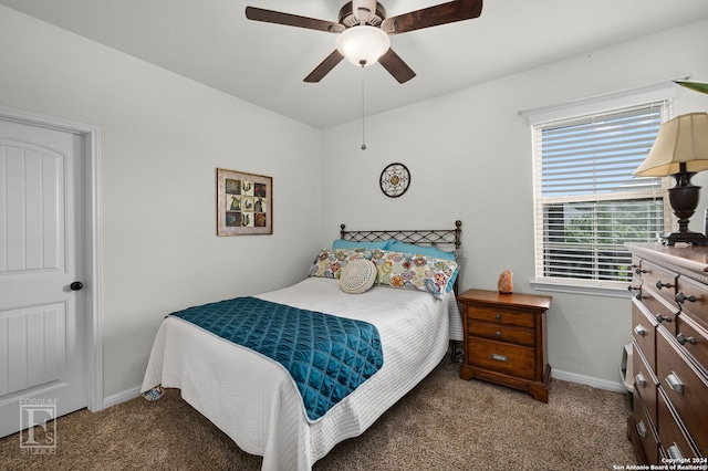 bedroom with ceiling fan and dark colored carpet