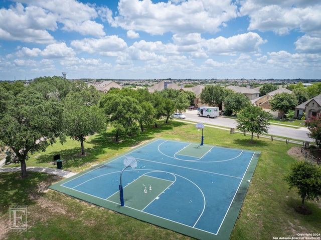 view of sport court with a yard