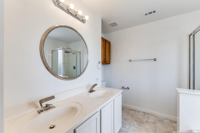 bathroom featuring vanity and a shower with door