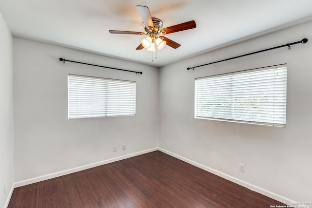 spare room with ceiling fan and dark hardwood / wood-style floors