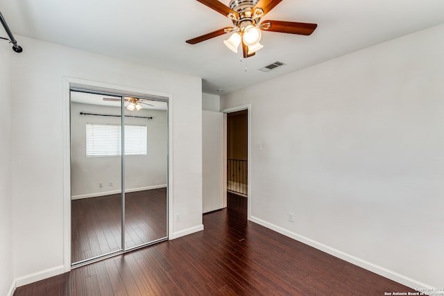 unfurnished bedroom with a closet, hardwood / wood-style flooring, and ceiling fan