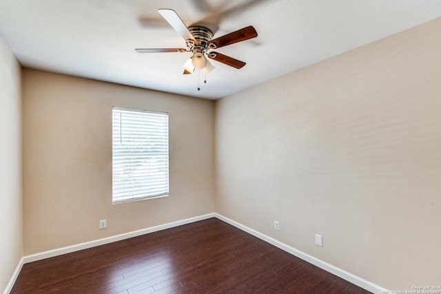 empty room with dark hardwood / wood-style floors and ceiling fan