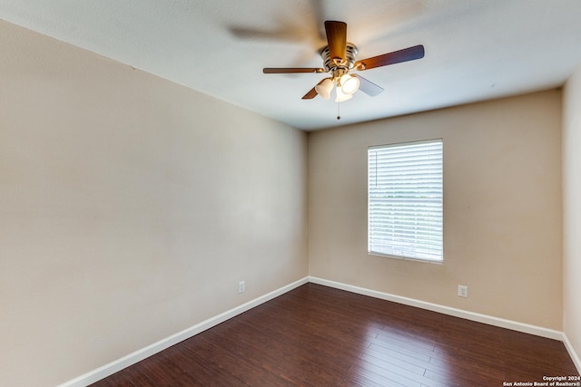 unfurnished room with dark wood-type flooring and ceiling fan