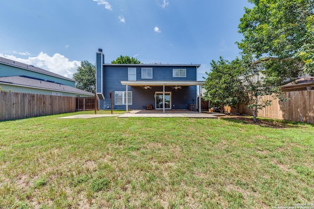 back of house with a patio area, ceiling fan, and a lawn