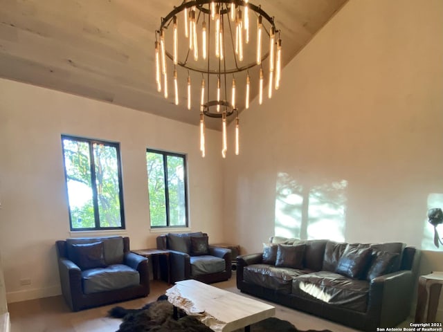 living room with plenty of natural light, a chandelier, lofted ceiling, and wood ceiling