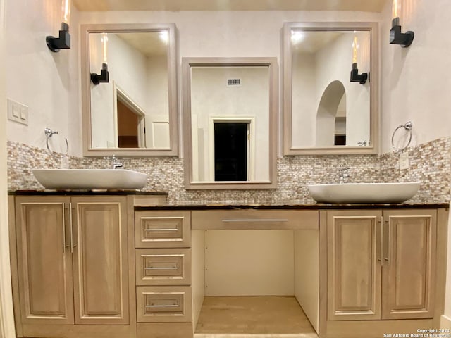 bathroom with vanity and decorative backsplash