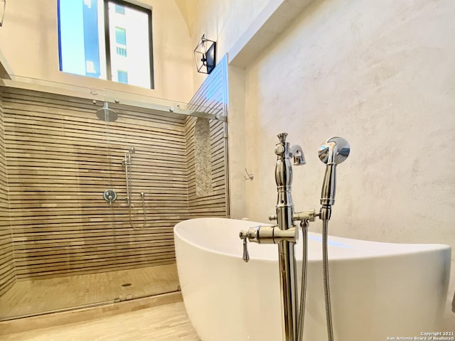 interior space featuring separate shower and tub and sink